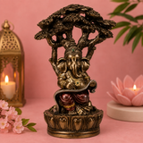 Ganesha lisant sous l'arbre - Sagesse & Connaissance (15x11x23 cm)